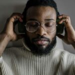Close-up of a Man Wearing Eyeglasses Listening to Music